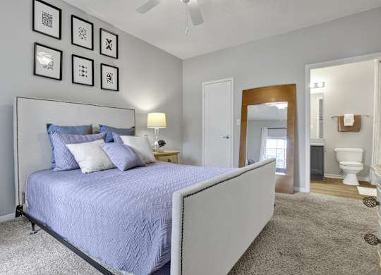 Bedroom with en-suite bathroom at Village at Caldwell Mill Apartments in Birmingham, AL