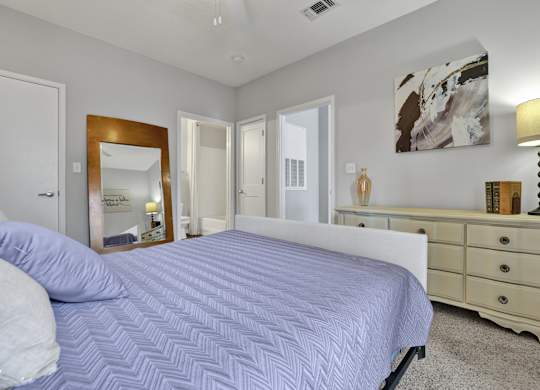 Bedroom with en-suite bathroom at Village at Caldwell Mill Apartments in Birmingham, AL