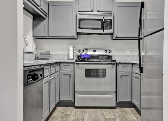 A remodeled kitchen with stainless steel appliances at Village at Caldwell Apartments in Birmingham, AL