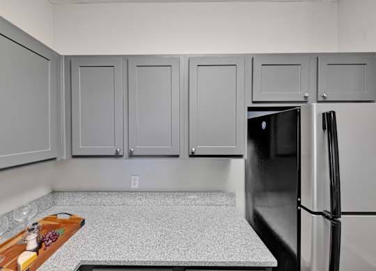 A remodeled kitchen with stainless steel appliances at Village at Caldwell Apartments in Birmingham, AL