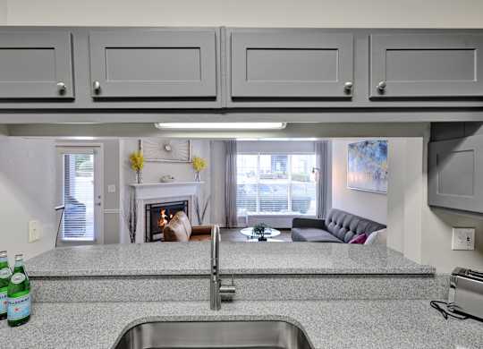 Kitchen with granite countertops and gooseneck faucet at Village at Caldwell Apartments in Birmingham, AL