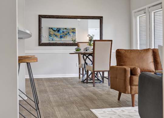 a living room and dining room at Village at Caldwell Mill apartments in Birmingham, AL