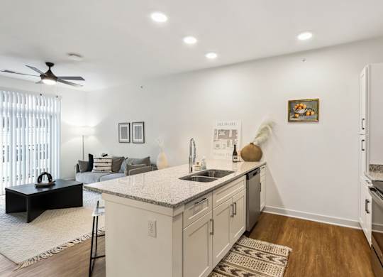A kitchen with a white countertop and a ceiling fan.
