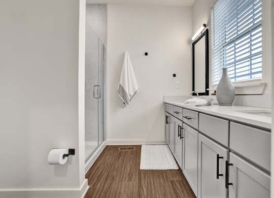 Bathroom with double vanity and quartz countertops at West Row Lofts and Townhomes in Birmingham, AL