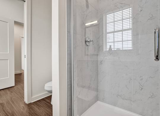 En-suite bathroom with stand-alone shower at West Row Townhomes and at West Row Townhomes at West Row Lofts and Townhomes in Birmingham, AL