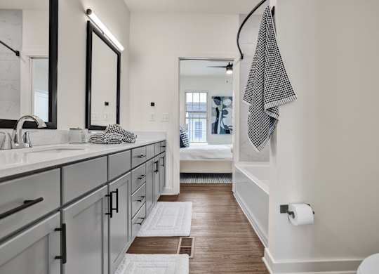 A bathroom with a checkered towel hanging on the wall.