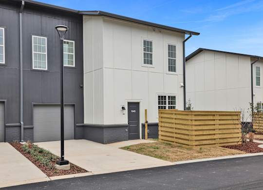 A modern two-story townhouse with fenced pet yard at West Row Lofts and Townhomes in Birmingham, AL