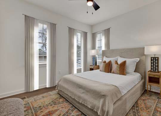 Bedroom with natural light and ceiling fan at West Row Townhomes and