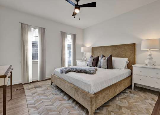 Bedroom with ceiling fan and tall ceilings at West Row Townhomes and at West Row Townhomes at West Row Lofts and Townhomes in Birmingham, AL