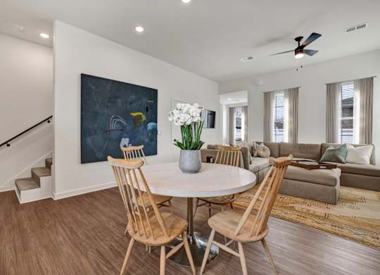 Open floor plan living and dining area with wood-designed flooring at West Row Townhomes and at West Row Townhomes at West Row Lofts and Townhomes in Birmingham, AL