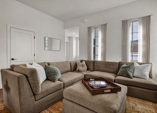 A living room with wood-style flooring at West Row Townhomes and at West Row Townhomes at West Row Lofts and Townhomes in Birmingham, AL