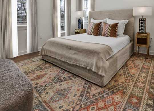 Bedroom with ceiling fan and wood-style flooring at West Row Townhomes and Apartments in Birmingham, AL