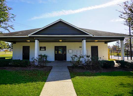 A small building with a porch and a covered walkway.