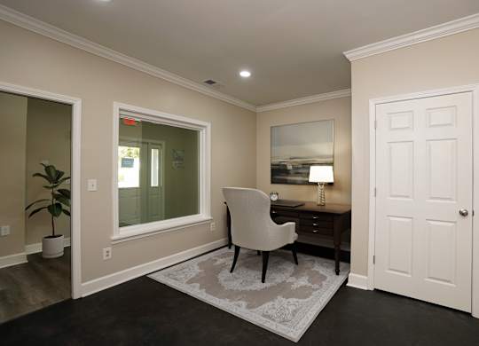 A room with a desk and chair in it.