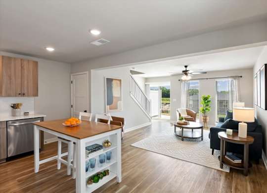 A modern kitchen with a dining table and chairs.