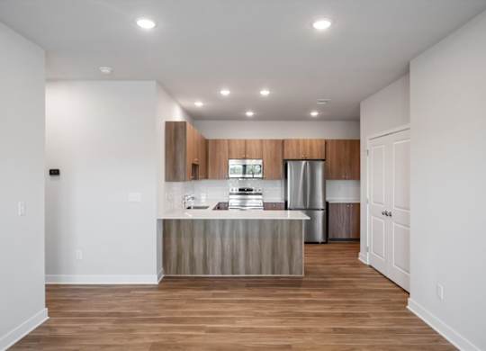 A kitchen with a wooden island and white walls.