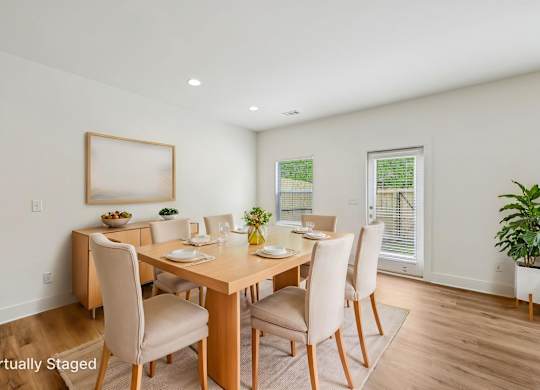 A dining room with a wooden table and chairs.
