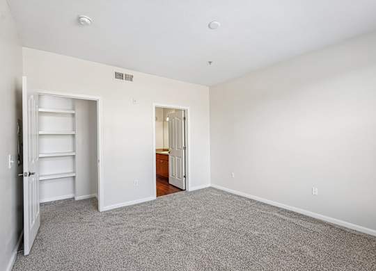 A room with a white door and a white shelf.