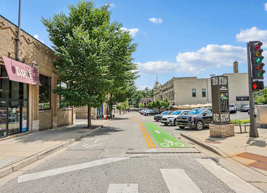 A street view with a crosswalk and a traffic light.