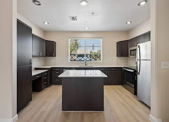 A kitchen with dark brown cabinets and a white refrigerator.