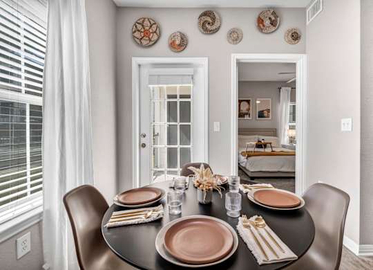 a dining room with a table and chairs