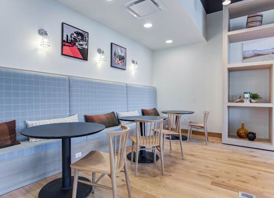 A dining area with a table and chairs.