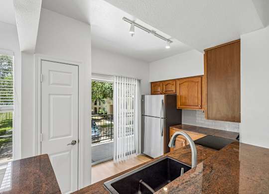 A kitchen with a brown counter tops at St Moritz in Dallas Texas