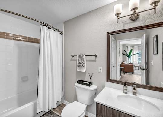 a bathroom with a bathtub and a toilet next to a sink