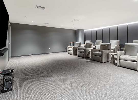 a waiting room filled with chairs and a tv