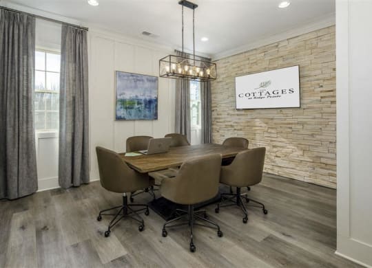 a dining room with a table and chairs and a brick wall