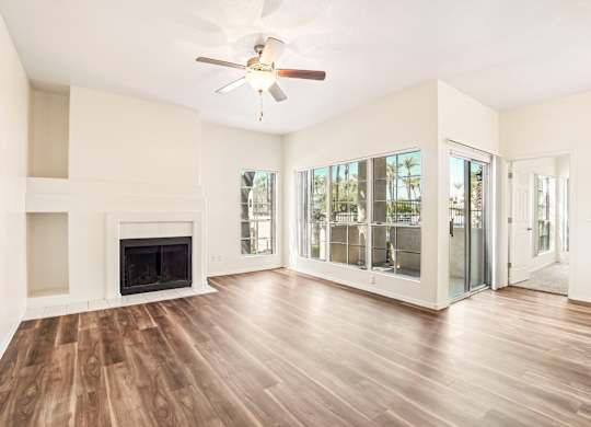 A spacious living room with a fireplace and sliding glass doors.