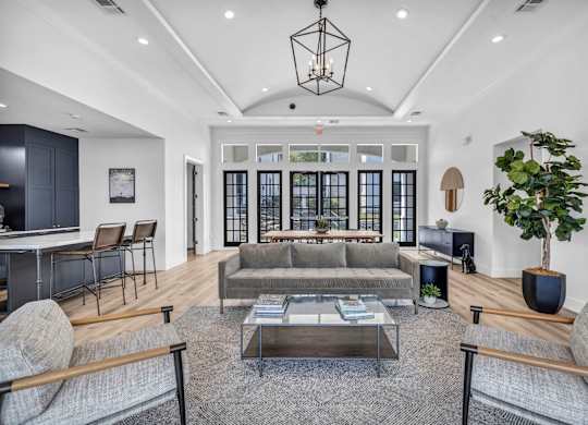 a living room filled with furniture and a large window