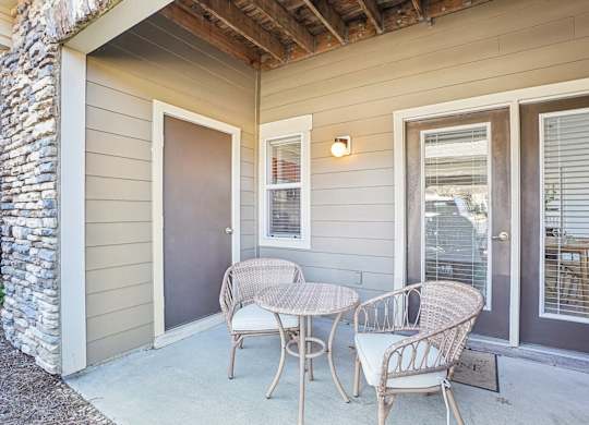 A patio with a table and chairs.