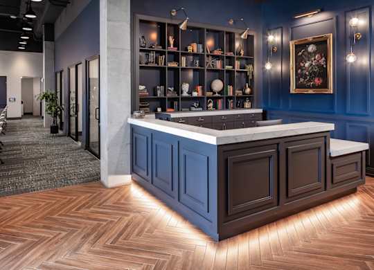 a view of the reception area with blue walls and wood flooring
