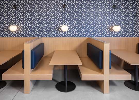 a rendering of a booth with tables and chairs in a restaurant