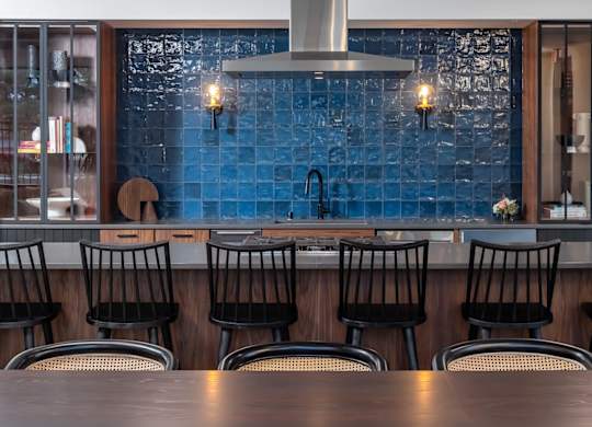 a bar with black chairs and a wooden table