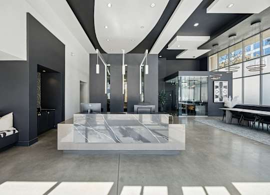 A modern living room with a marble coffee table and a black and white sofa.
