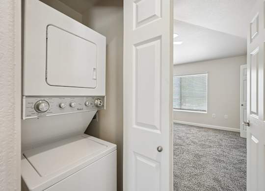 A white washing machine and dryer in a small laundry room.