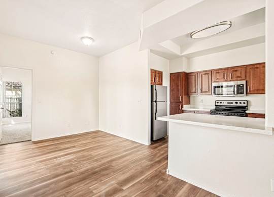A kitchen with wooden cabinets and a white counter.