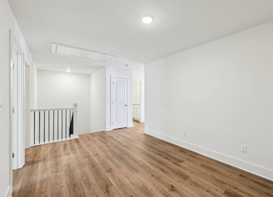 A room with wooden floors and white walls.