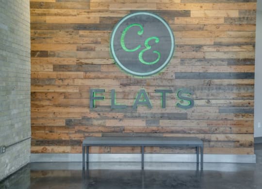 CE Flats logo on wooden wall in lobby