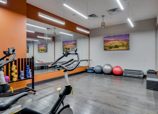 Fitness studio with spinning bikes, large mirrors, and Pilates equipment C&E Living in St Paul, MN