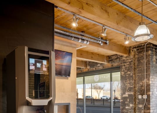 a kitchen with a stainless steel refrigerator and a table C&E Living in St Paul, MN
