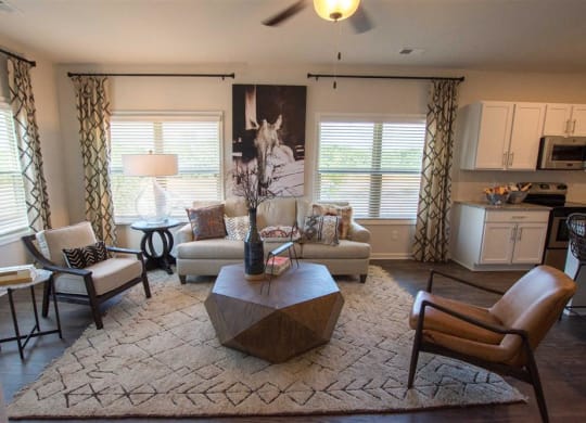 a living room with chairs and a table