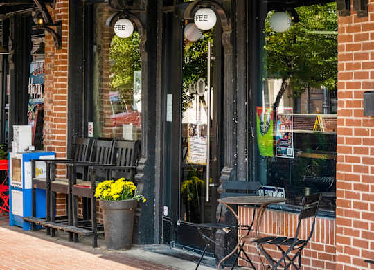 A storefront with a black awning and a sign that says