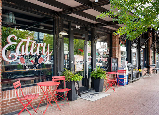 A red chair is in front of a window with a sign that says Eatery.