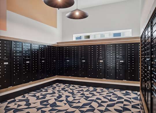 A room with black lockers and a patterned floor.