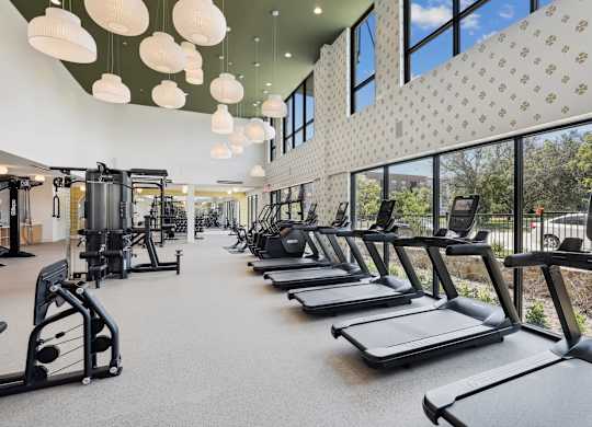 A gym with treadmills, weights, and exercise machines.