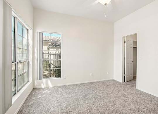 A room with a grey carpet and white walls.