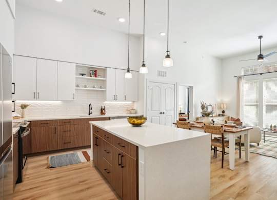 A modern kitchen with wooden cabinets and a white countertop.